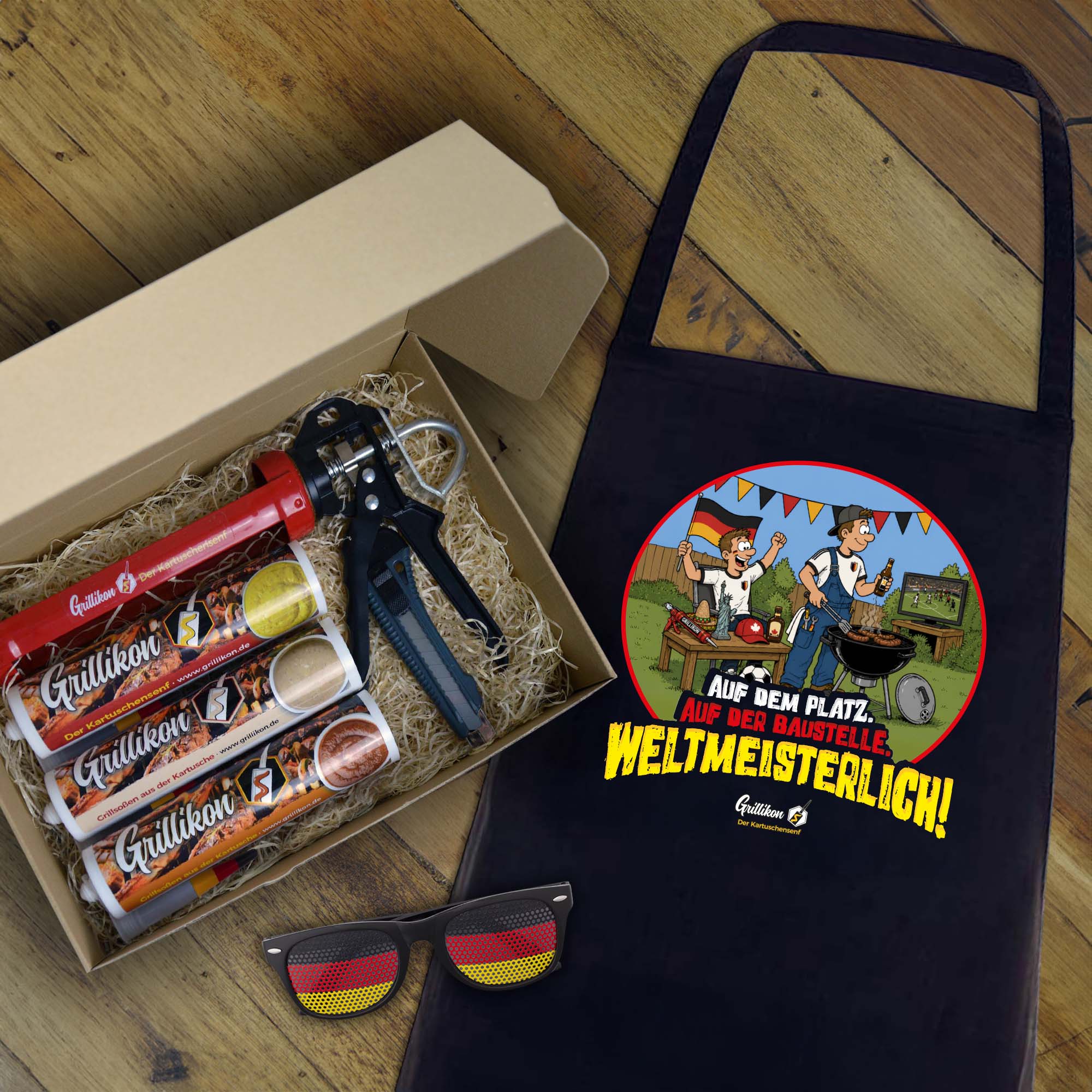 Grillikon Geschenkset „WM-Edition“ im Geschenkkarton mit 3x 300 ml Kartuschen für Senf und Soßen, Kartuschenpistole, WM-Grillschürze und Deutschland-Fanbrille